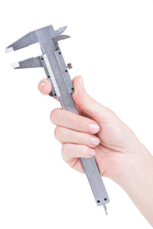 Female hand holding a caliper over white backgroundの写真素材