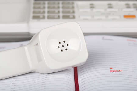 Receiver of answerphone over notepadの写真素材