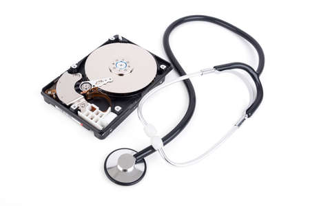 hard disk with a sthetoscope isolated on white backgroundの写真素材