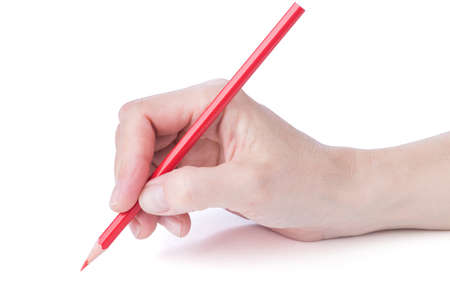 female hand with a red pencil over whiteの写真素材