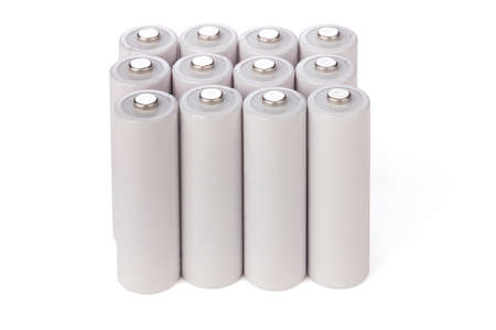 AA batteries stand in a row over whiteの写真素材