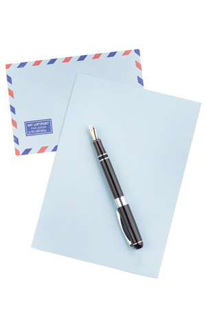 Vintage air mail envelope with a letter and fountain pen over whiteの写真素材