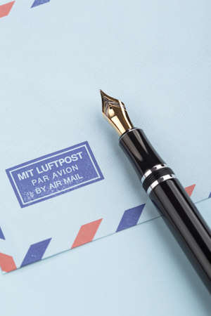Vintage air mail envelope with a letter and fountain penの写真素材