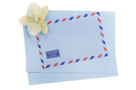 Vintage air mail envelope with orchid over white backgroundの写真素材