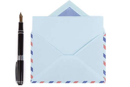 vintage air mail envelope with a letter and fountain pen over white