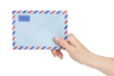 female hand holding air mail envelope over whiteの写真素材