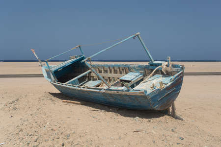 Old beached fishing Boat on the coast of Red Seaの写真素材
