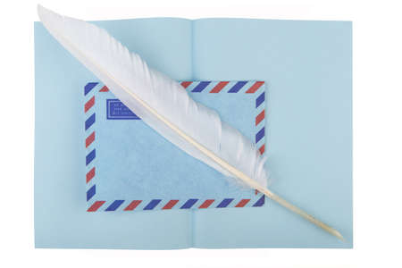 vintage air mail envelope with a letter and antique quill over whiteの写真素材