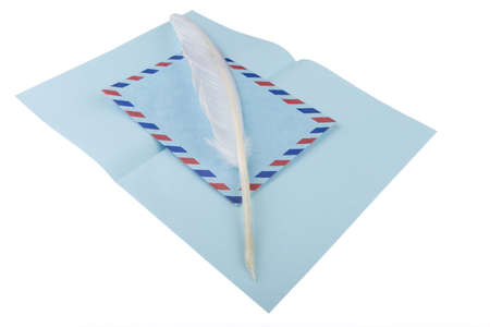 vintage air mail envelope with a letter and antique quill over whiteの写真素材
