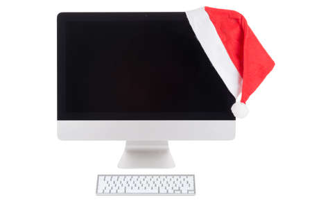 Red santa hat on the Modern Computer Monitor over whiteの写真素材