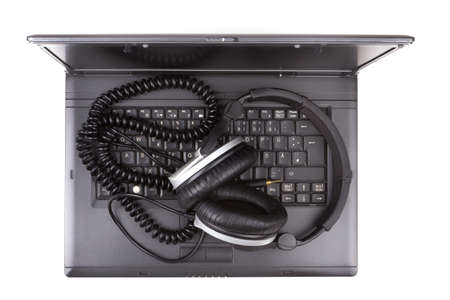 Notebook Computer with headphones over white background