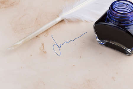 White Feather pen and ink bottle on old paperの写真素材