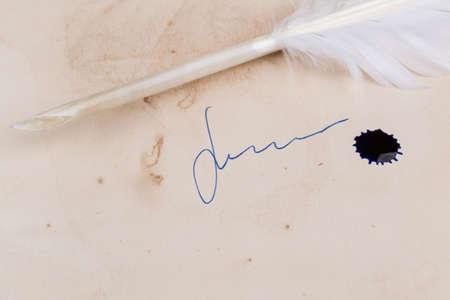 White Feather pen on old paper with signature