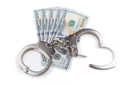 handcuffs on the background of banknotes dollarの写真素材