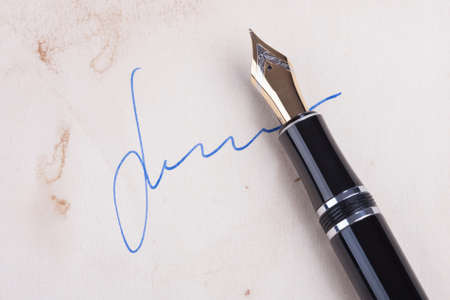 Signature on old paper with old fountain penの写真素材