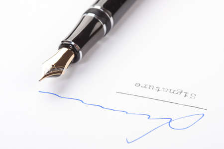 Signature on white paper with old fountain penの写真素材