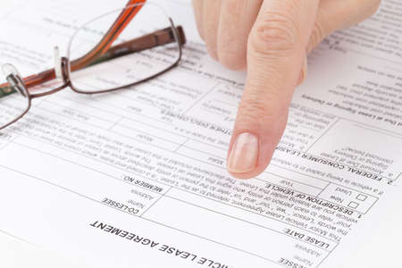 female hand points to a string in the lease agreementの写真素材