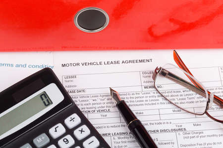 motor vehicle lease agreement with fountain pen and calculatorの写真素材