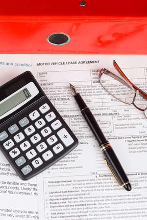 motor vehicle lease agreement with fountain pen and calculatorの写真素材