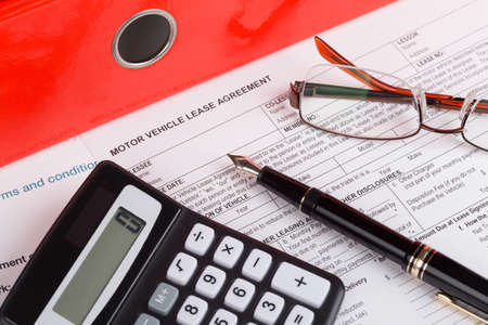 motor vehicle lease agreement with fountain pen and calculatorの写真素材