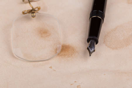 fountain pen and pince-nez on the old paperの写真素材