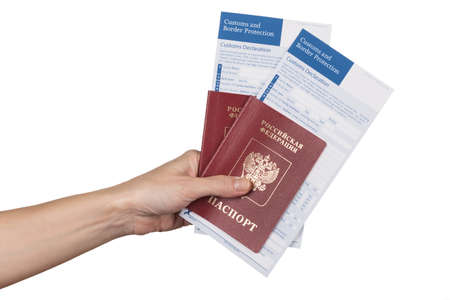 female hand holding russian travel passports with the customs declaration