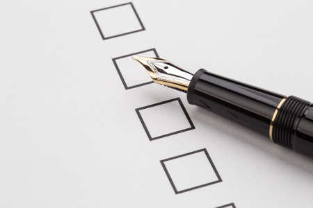 fountain pen and checkbox on the white paperの写真素材