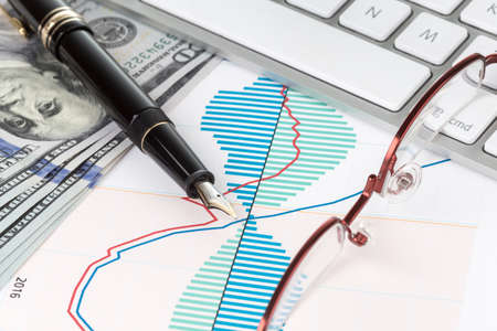 Dollars and fountain pen with eyeglasses