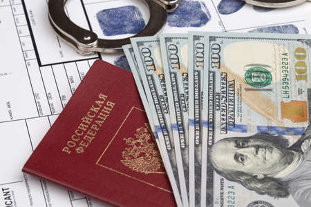Fingerprint card with russian travel passport and handcuffs
