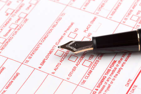 health insurance claim form with fountain pen