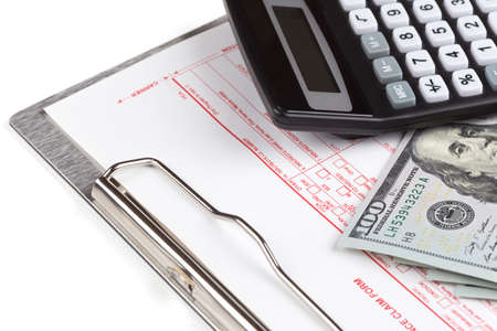 health insurance claim form on the clipboard with money