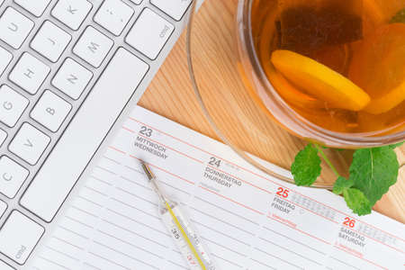 Lemon Tea with mercury thermometer and computer keyboard