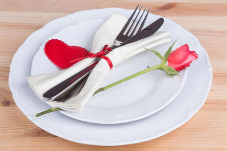 Heart on plate with fork and knife over wooden backgroundの写真素材