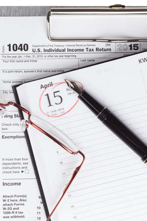 Income Tax Return Form with fountain pen and glassesの写真素材