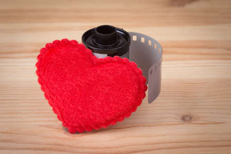 film cartridge with heart over wooden backgroundの写真素材