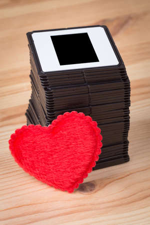 slides over wooden background with heartの写真素材