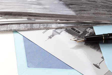 Vintage airmail envelope with a photo and fountain pen over white