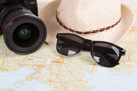 Europe map with camera and straw hat with sunglassesの写真素材