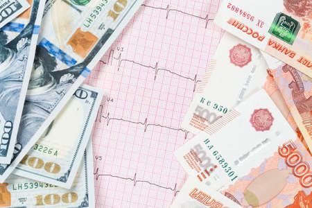 Black word crisis dollar and ruble banknotes on cardiogramの写真素材
