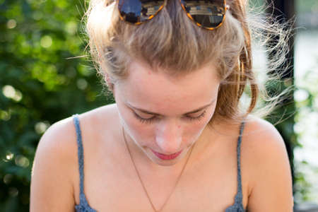 Young woman with sunglasses in her hairの写真素材