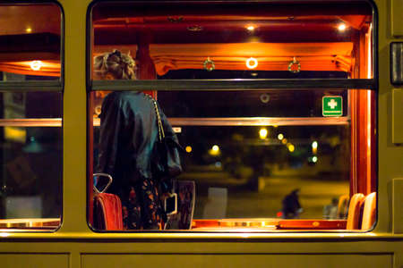 woman on the tram at nightの写真素材