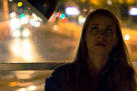 woman on the tram at nightの写真素材