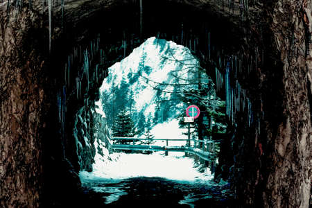 tunnel with icicles in winterの写真素材