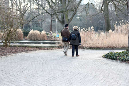 Old married couple going for a walk outdoorの写真素材