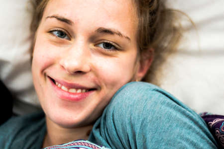 young woman woke up happy and laughing