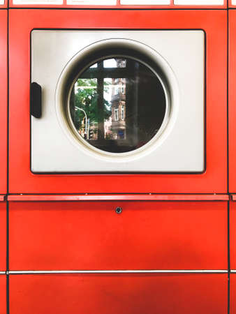 red retro washing machine in coin laundryの写真素材