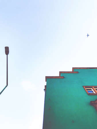 street light, green building and aeroplaneの写真素材