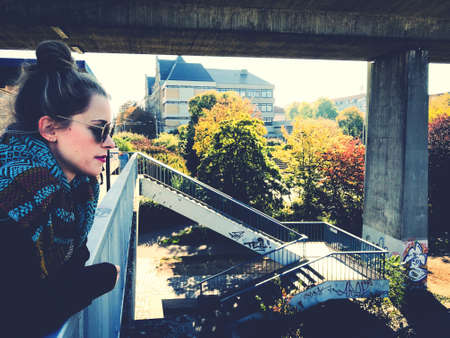 girl in the city leaning on a railing