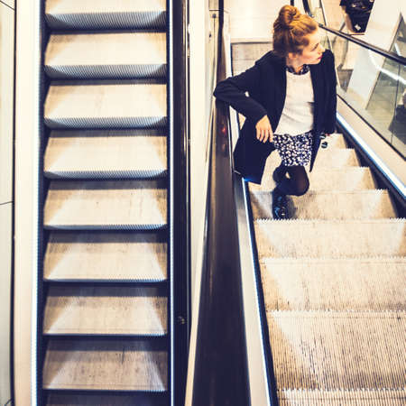 girl standing on an escelator