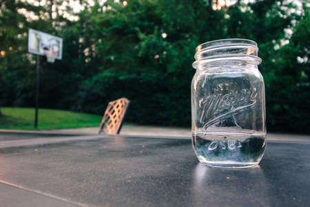 drinking a glass of water in the backyard at eveningの写真素材
